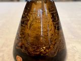 a brown vase sitting on a table with a white table cloth