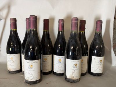 six bottles of wine are lined up in a row on a table