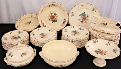 a lot of plates and bowls on the table