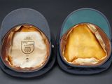 pair of blue and brown baseball caps with a crest on the front