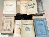 several books are stacked on top of each other on a table