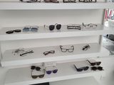 many pairs of glasses on the shelves in the store