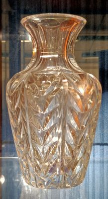 a glass vase that is sitting on a glass table