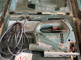 a green box with tools on it sitting on a table