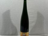 a bottle of wine sitting on top of a white table