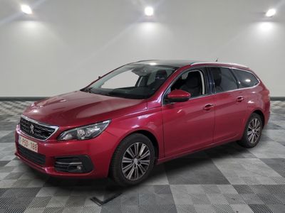 a red car is parked in a room with a checkered floor