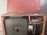 an old wooden box with a metal door on it