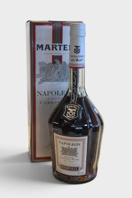 a bottle of liquor that is next to a box