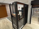 a room that has a glass door and a desk in it