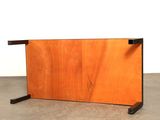 an image of a wooden table with a black metal base