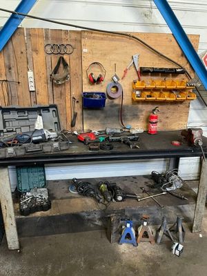 a workbench with tools on it in a garage