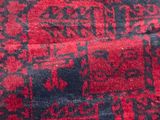 an image of a red and black area rug with a design on it