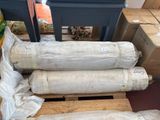 several rolls of paper sitting on top of a pallet next to boxes