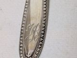 a silver spoon with a silver handle on a table