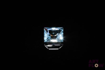 a square blue topazte gems in a black background