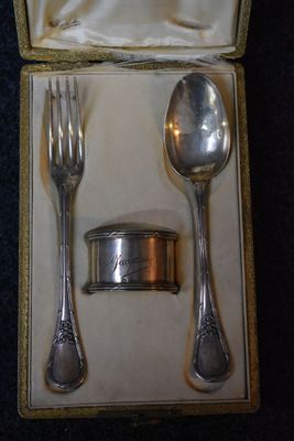 a silver spoon and fork in a box on a table