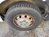 a flat tire on the side of a white truck