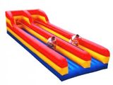 an inflatable water slide with two people on it