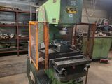 a machine that is sitting in a warehouse with a lot of tools