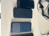 several cell phones are lined up on a table with a phone in front of them