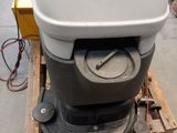 a white toilet sitting on top of a wooden pallet