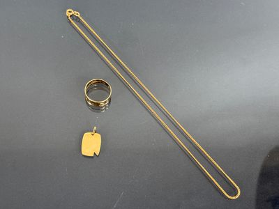 two rings and a gold chain on a table