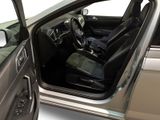 the interior of a car with the door open and the driver ' s seat down