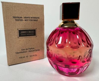 the bottle of perfume is next to the box on the table