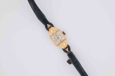 a close up of a wrist watch on a white surface