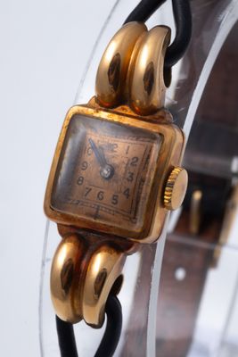 a watch that is sitting on top of a glass stand