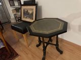 a small table with a picture on it in a room