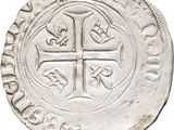 a close up of a coin with a cross on it