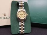 an image of a rolex watch sitting on a table next to a wallet