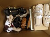 many pairs of shoes in a box on the floor