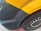 a close up of a yellow and black car parked on the side of the road