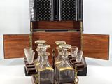 bottles and glasses in a wooden case on a white background