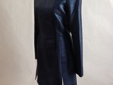 navy blue jacket on a mannequin stand with a white background