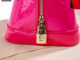 a pink purse sitting on top of a table