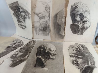 sketches of a man ' s head, a woman ' s face, and a man ' s head