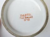 a white plate with orange writing on it on a table