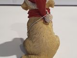 a figurine of a dog wearing a santa hat