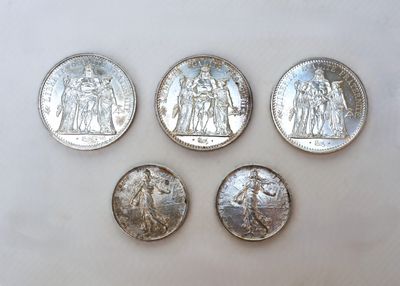 four different types of silver coins are shown on a white surface