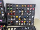 a lot of different types of beer caps in this case