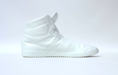 white high top sneakers on a white surface with a white background