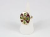 a close up of a silver ring with multi colored stones on it