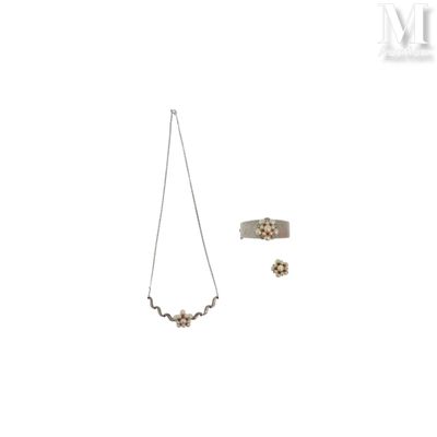 two pieces of jewelry sitting on top of a white surface