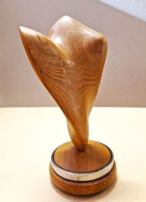 a wooden sculpture that is on a table
