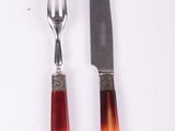 two forks and a knife sitting next to each other