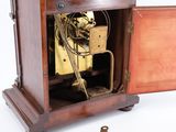 a small wooden clock with a key in it