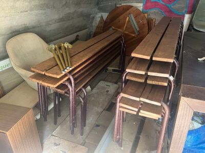 many wooden tables and chairs in a room